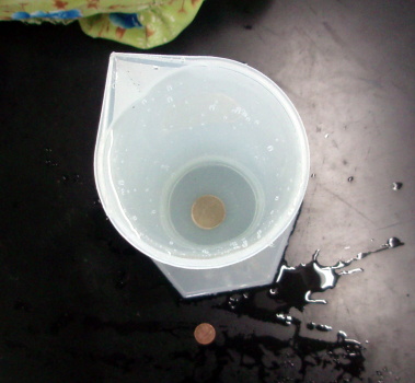 Penny in the bottom of a measuring cylinder Penny in the bottom of a measuring cylinder