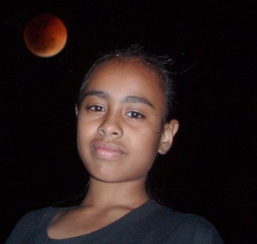 Composited image by GIMP of the lunar eclipse and Sharisey. By magnifying the moon and compositing the image with that of my daughter, a much more emotive image results.