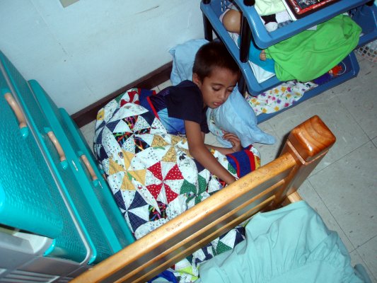 Too cute! He curled up in a ball, the wall, the dresser, the bed, and a set of shelves forming the four walls of his bed basket.